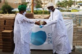 Mamadou Dia, World Water Council Governor, hands over soap bars to Soham El Wardini, Mayor of Dakar, Dakar, Senegal, 10 April 2020